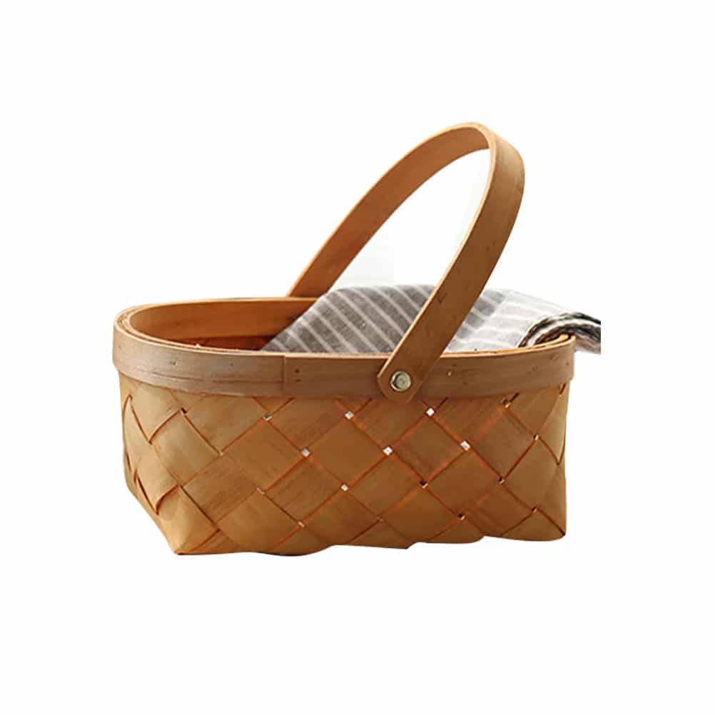 Small woven wicker basket with a wooden handle