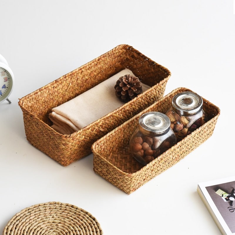 Small rectangular rattan storage basket with neatly worked edges – shown in a room setting