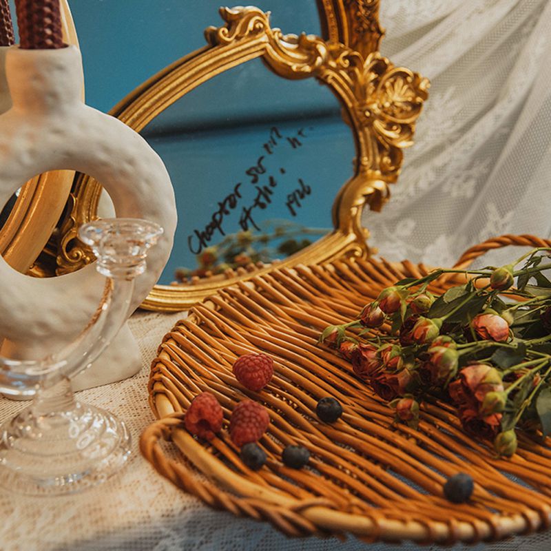Small slim round rattan tray with a smooth surface – shown in a room setting (4)