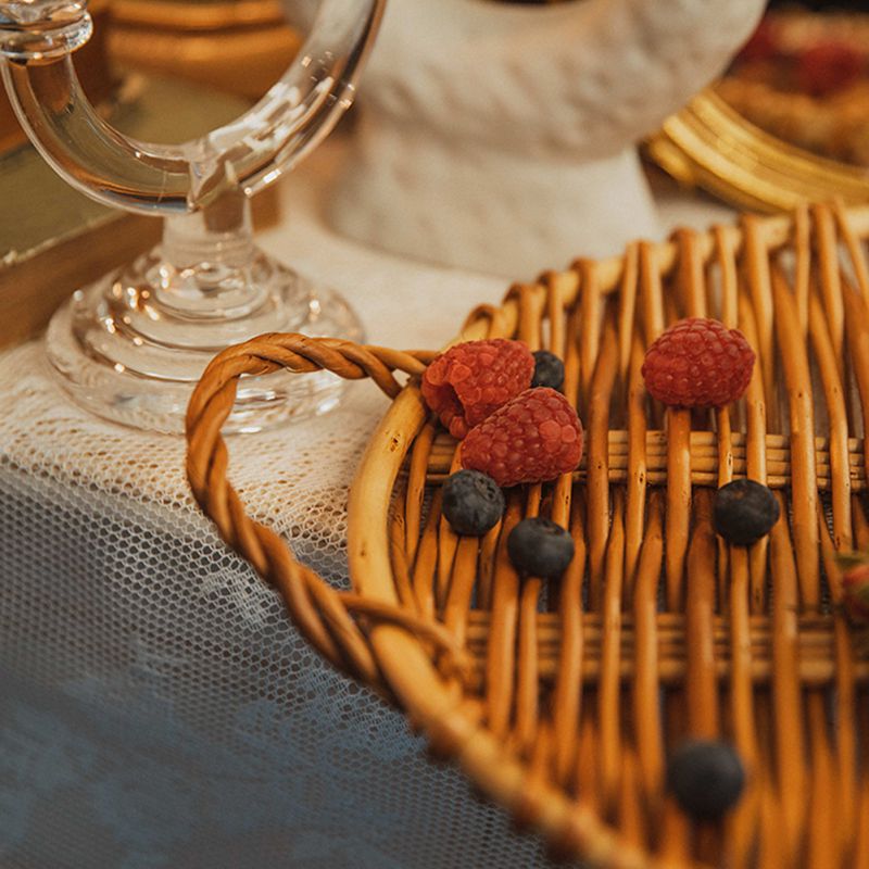 Small slim round rattan tray with a smooth surface – shown in a room setting (3)