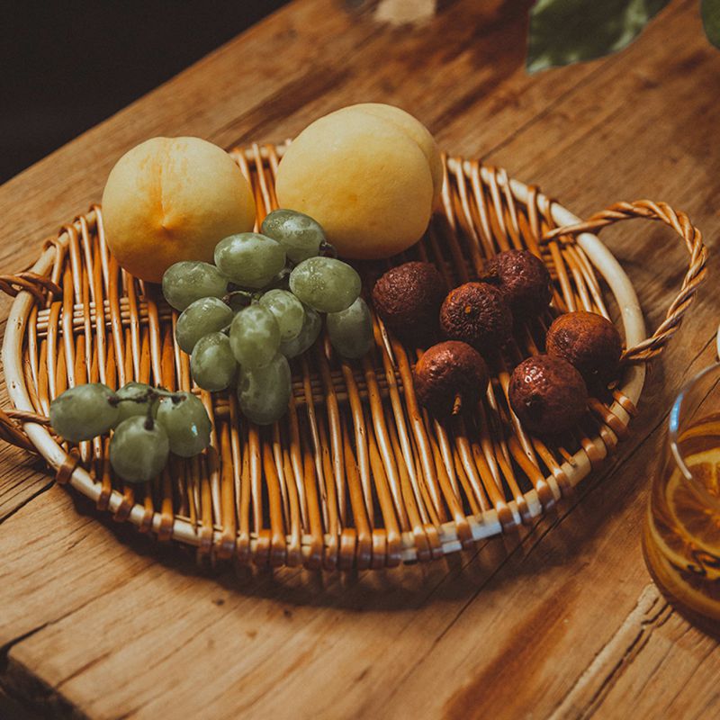 Small slim round rattan tray with a smooth surface – shown in a room setting