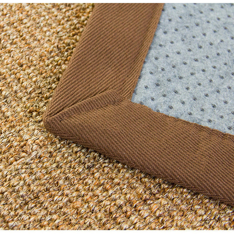 Small brown rectangular rattan rug with a braided border – close-up detail