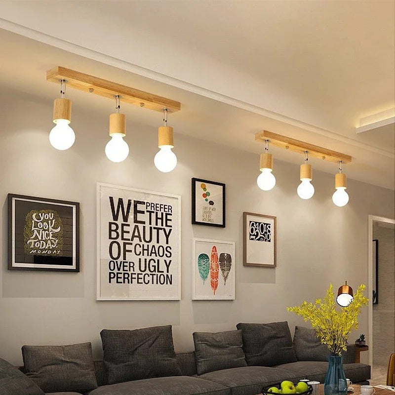 Three-head wood LED ceiling light with adjustable heads – shown lit in a room setting (2)