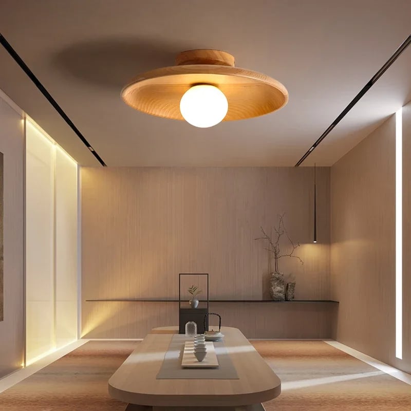 Nordic round light wood LED ceiling light with a matte finish – shown lit in a room setting (2)