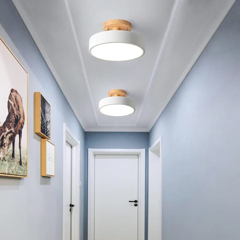 Nordic natural wood ring LED ceiling light with fine metal structure – shown lit in a room setting (2)