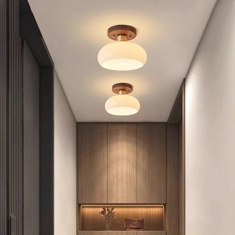 Modern wood frame LED ceiling light with translucent glass stone diffusers – shown lit in a room setting (2)