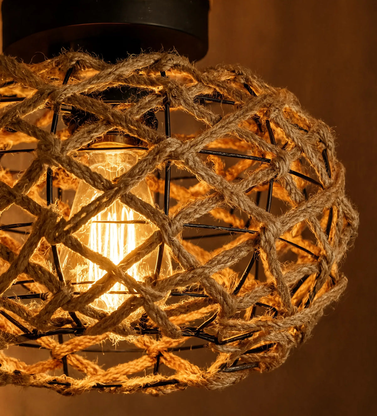 Symi knotted hemp rope dome ceiling light on a black steel frame – close-up detail, lit