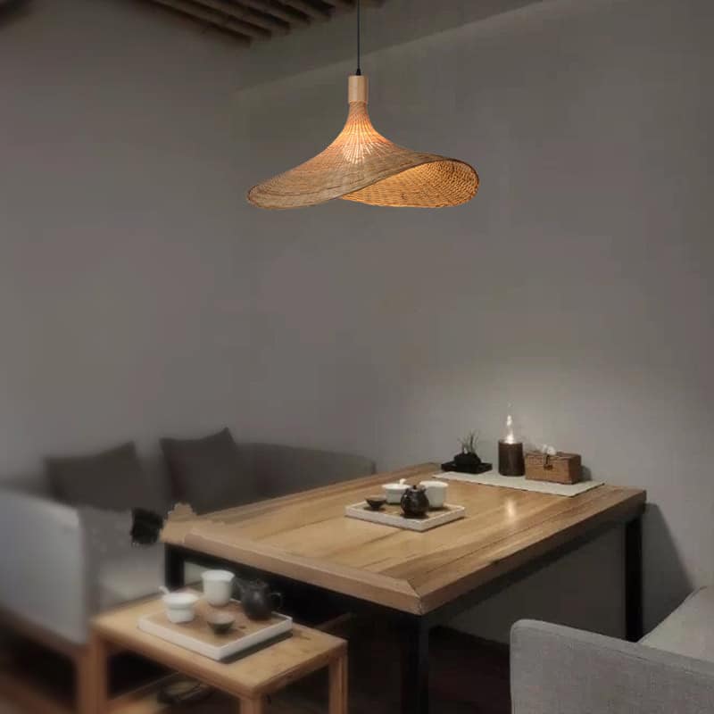 Round handmade rattan, bamboo and wicker ceiling light – shown in a room setting