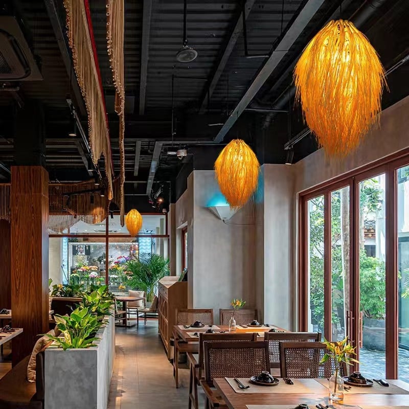 Japanese pastoral openwork rattan LED ceiling light – shown lit in a room setting (3)
