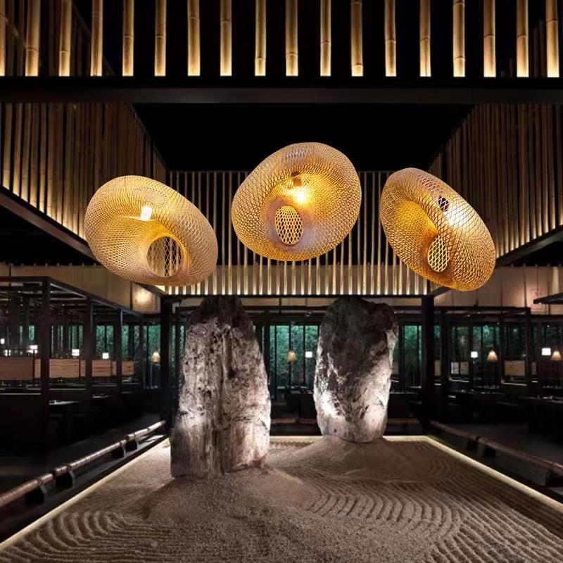 Chinese-style rattan and hand-braided bamboo slat LED ceiling light – shown lit in a room setting
