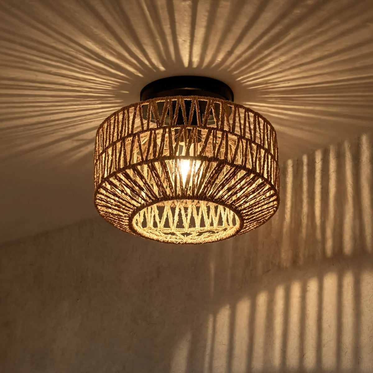 Lindos braided rope semi-flush ceiling light on a black steel frame – close-up detail, lit
