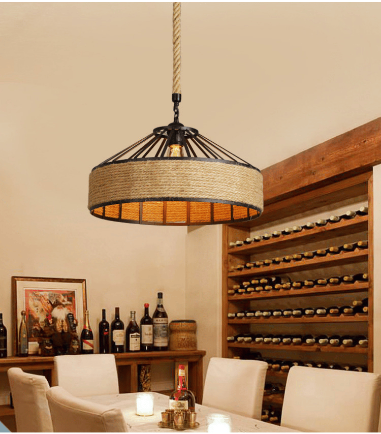 Industrial black frame rattan pendant light hung on raw rope – shown in a room setting