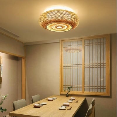 Open-weave hanging rattan ceiling light – shown lit in a room setting (2)