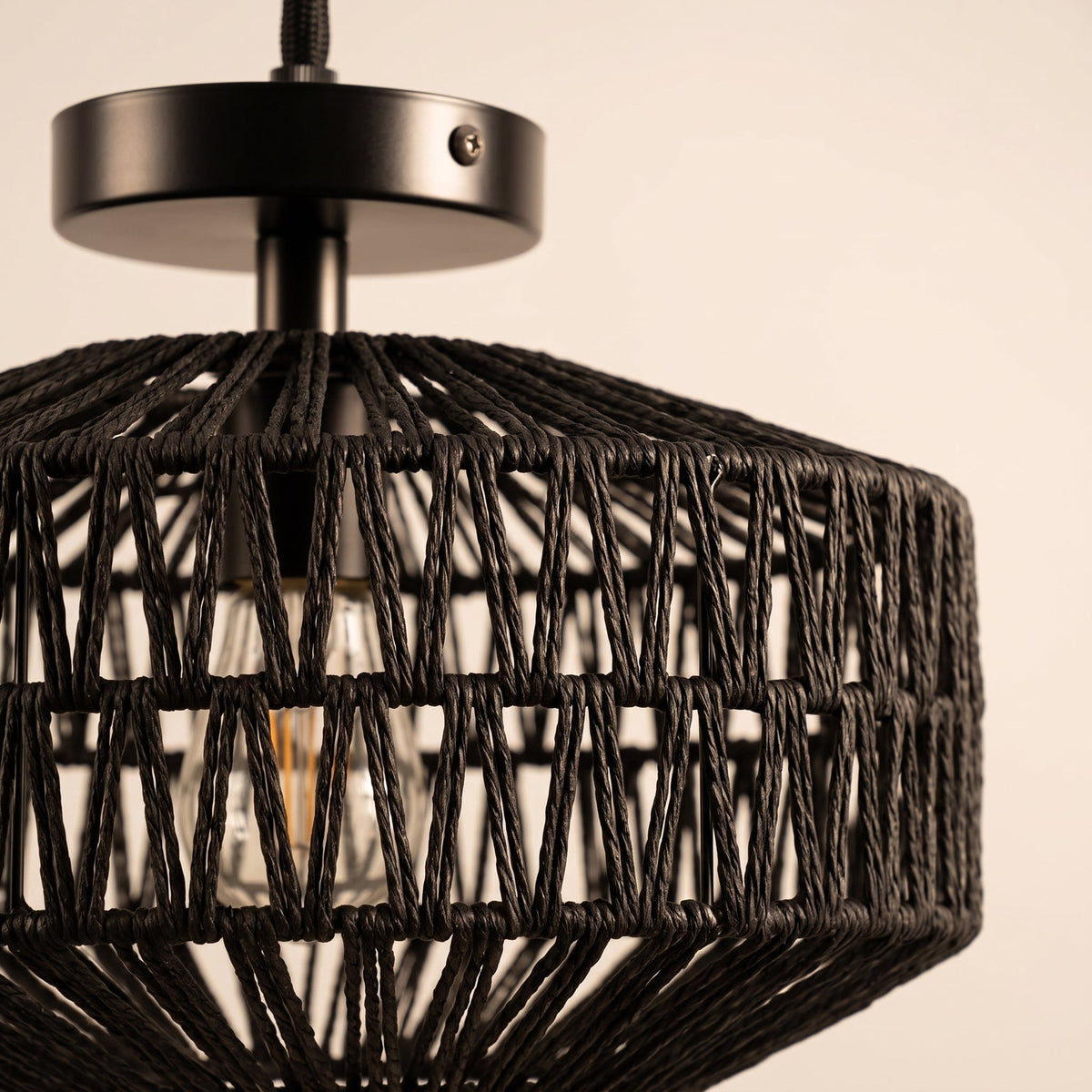 Black woven paper rope drum flush mount light on a black metal base – close-up detail
