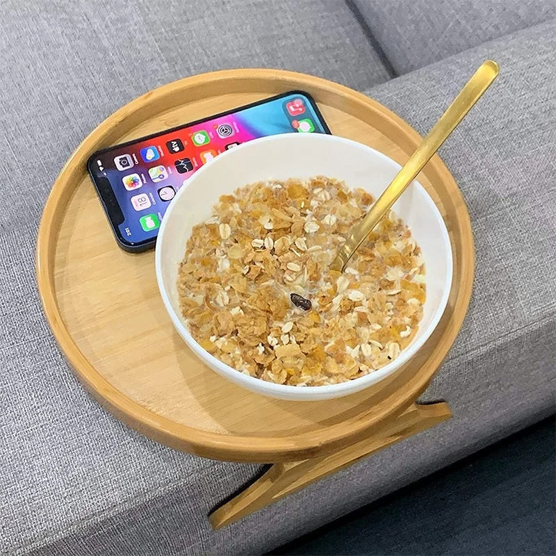 Round bamboo tray resting on a sofa armrest – shown in a room setting (2)