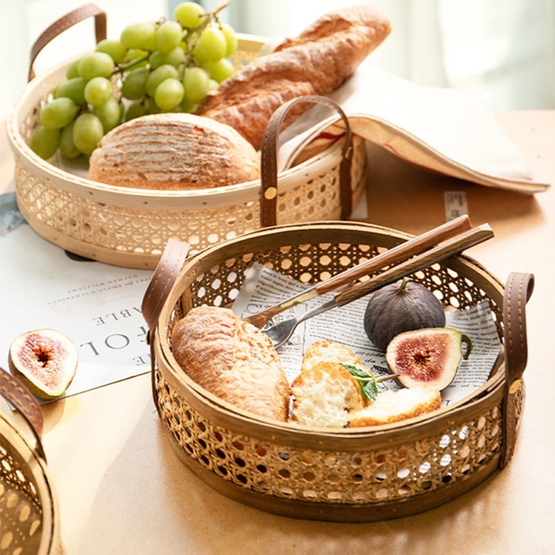 Round white rattan tray with a sewn leather handle – shown in a room setting (2)