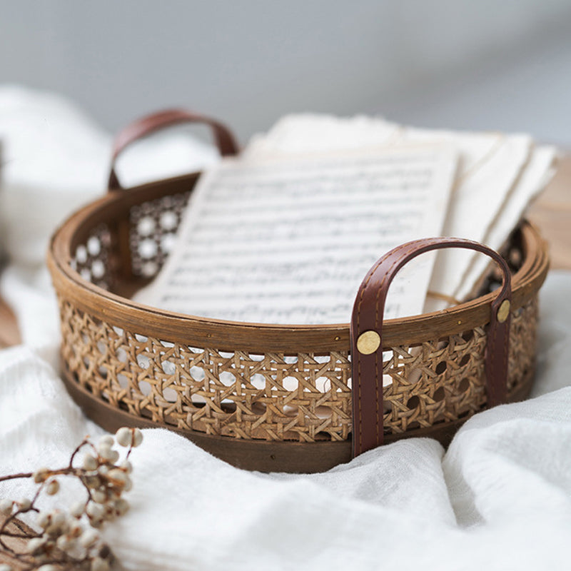 Round brown rattan tray with hand-sewn leather handles – shown in a room setting (3)