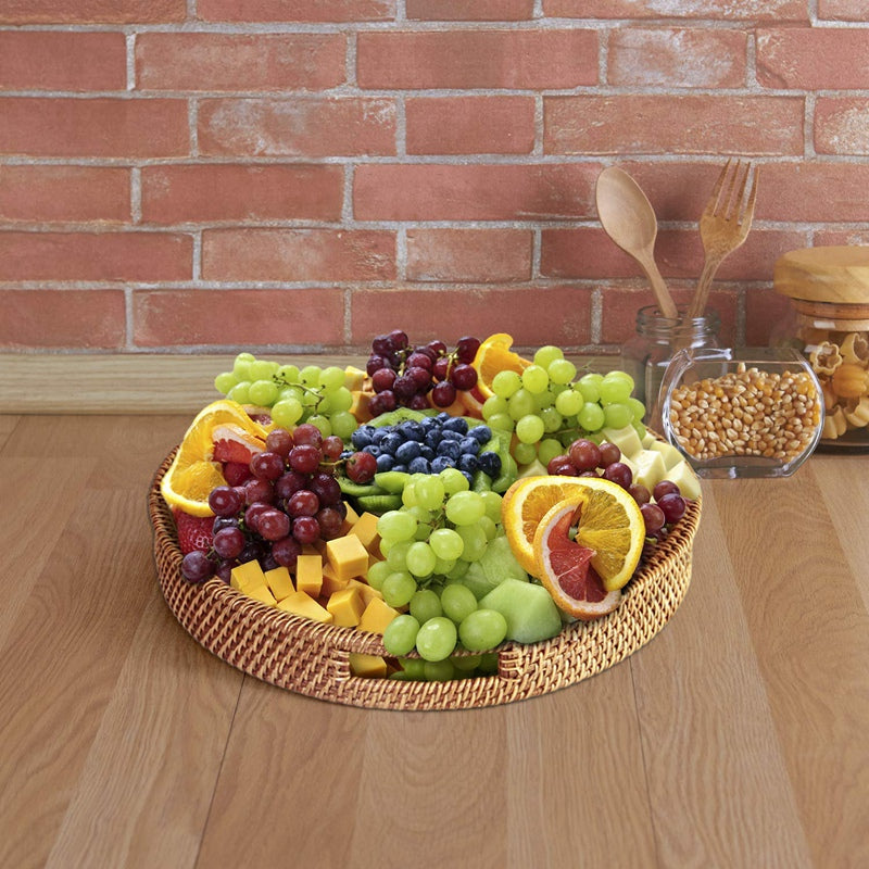 Round woven rattan serving tray with side cutout handles – shown in a room setting (3)
