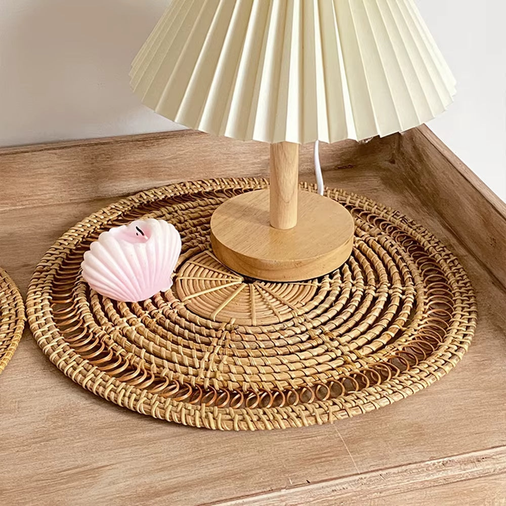 Round pastoral rattan decorative tray in a golden tone – shown in a room setting