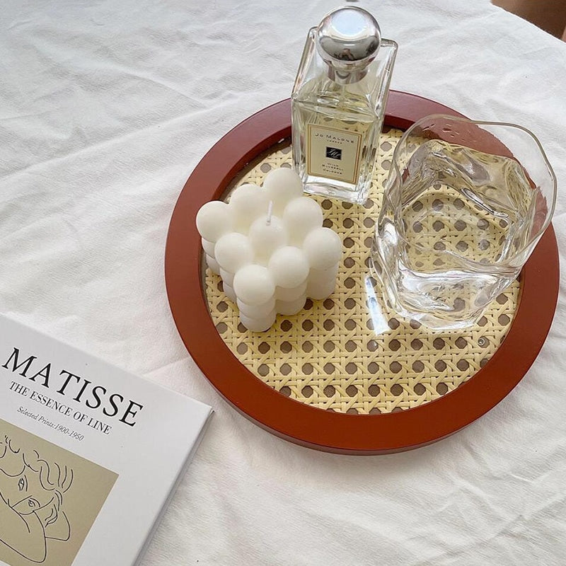 Round decorative rattan tray with a slightly raised rim – brown variant, shown in a room setting