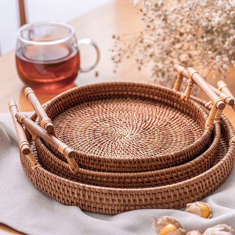 Round rattan tray with solid wood handles – shown in a room setting