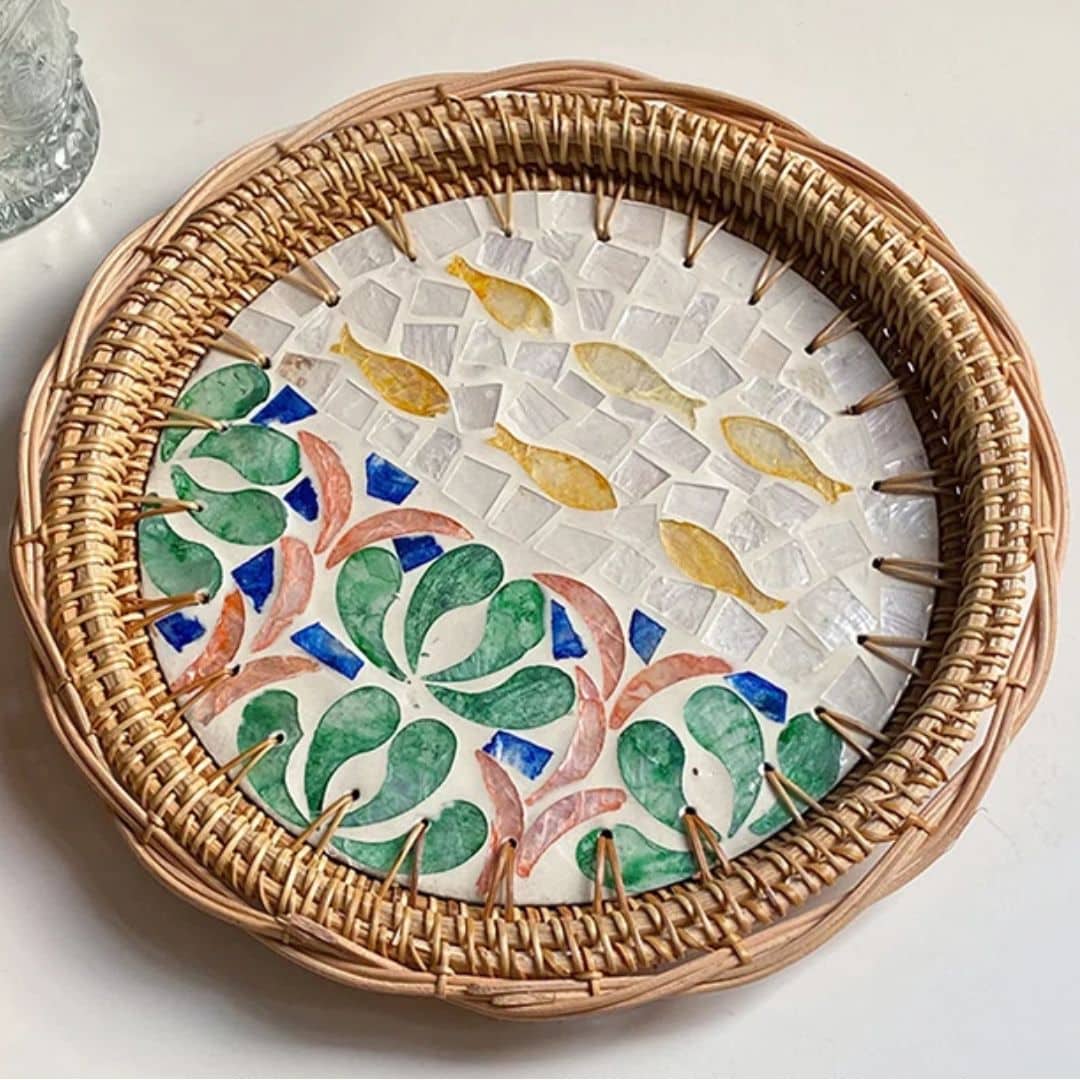 Hand-braided rattan tray with a vivid fish print – close-up detail