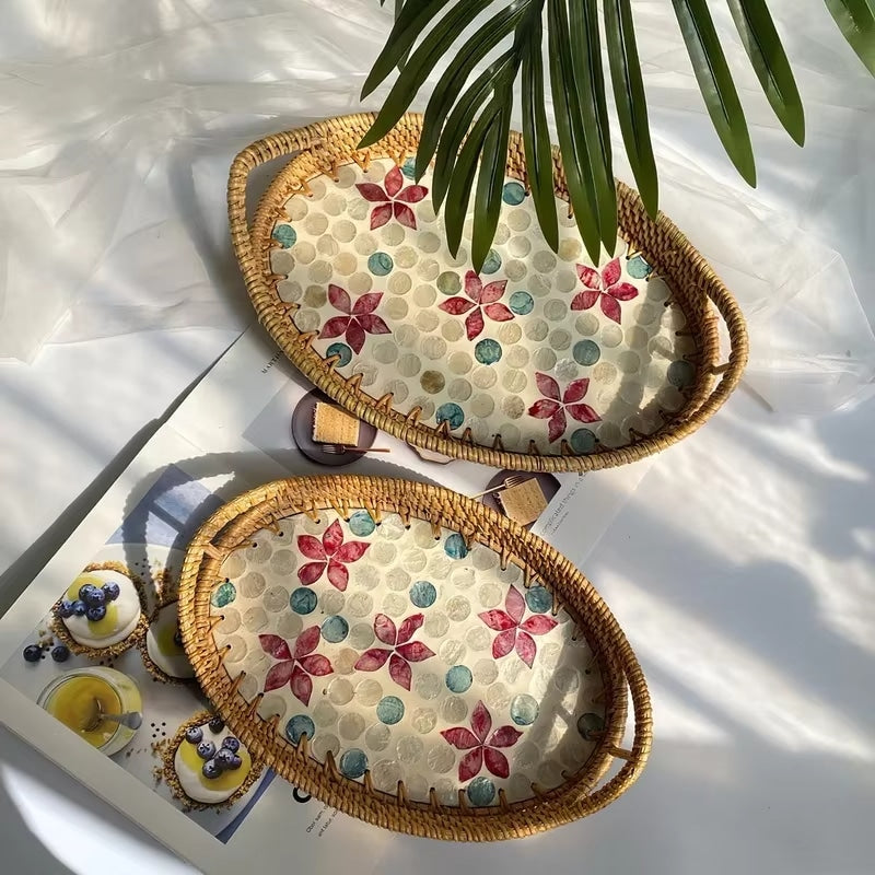 Oval rattan tray with a red floral base – shown in a room setting