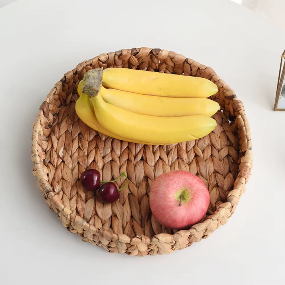 Round braided rattan tray with slightly raised edges – shown in a room setting