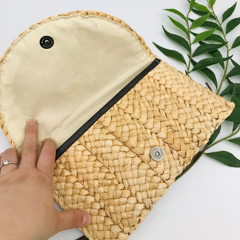 Handmade structured straw clutch – worn by a model