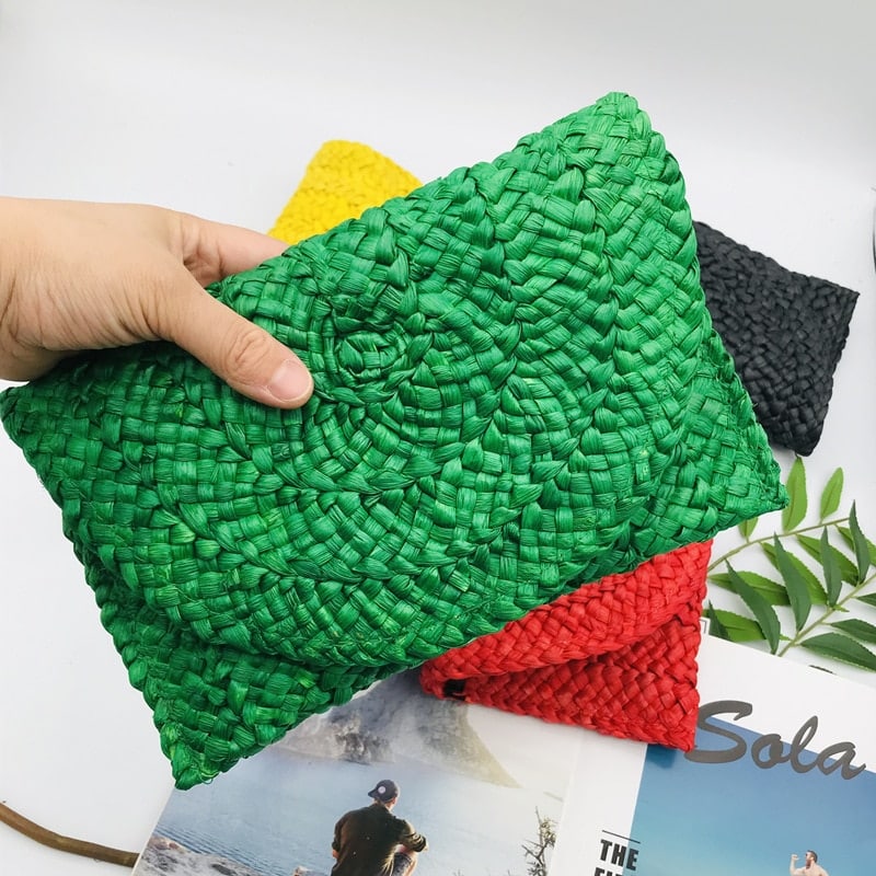 Handmade structured straw clutch – green variant, worn by a model