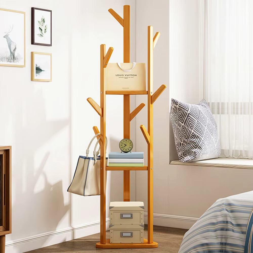 Bamboo clothing rack standing on a three-foot tripod base – shown in a room setting (2)