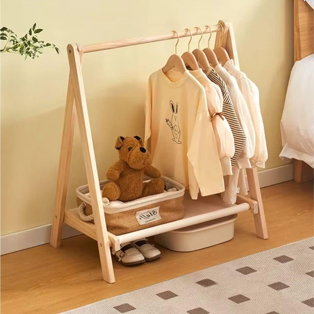 Modern folding wooden clothes rack with a cross frame – shown in a room setting (2)