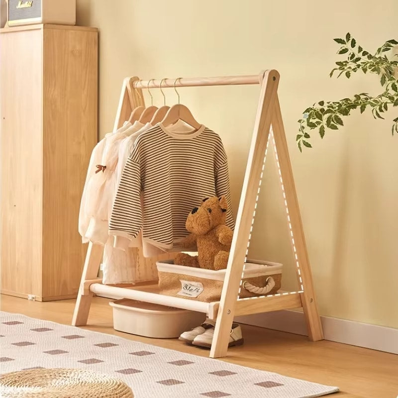 Modern folding wooden clothes rack with a cross frame – shown in a room setting (3)