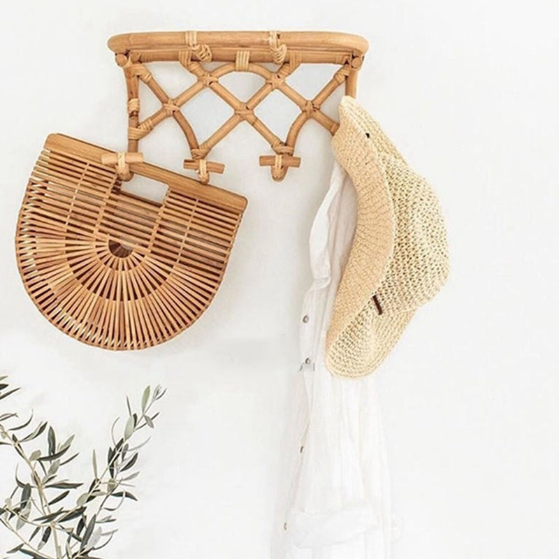 Crossed rattan wall coat rack with a top shelf and four hooks – shown in a room setting (2)