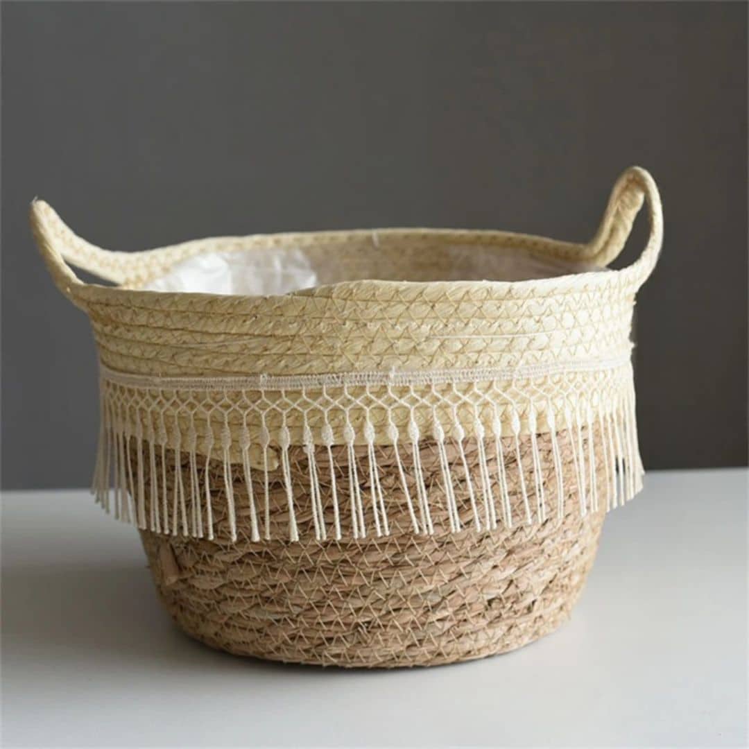 Curvy rattan planter trimmed with white tassels