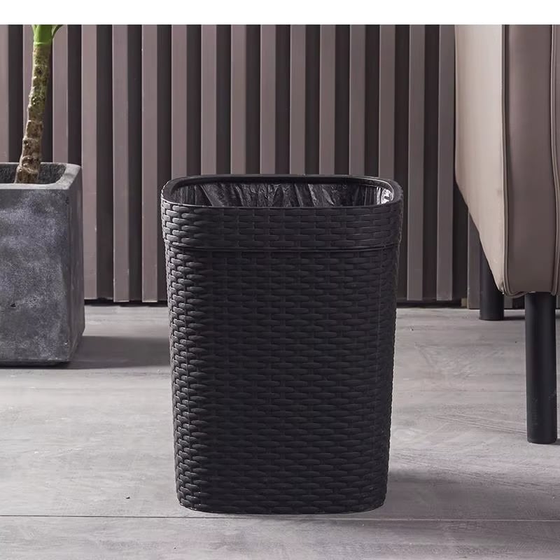 Modern black trash can with a rattan-look woven texture – shown in a room setting