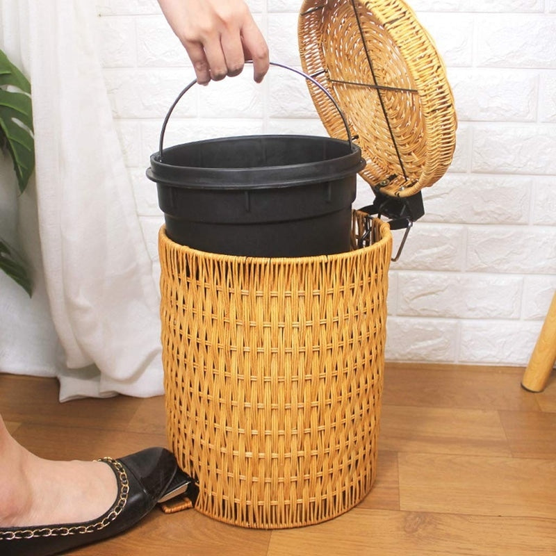 Woven rattan trash can with a foot pedal – shown in use