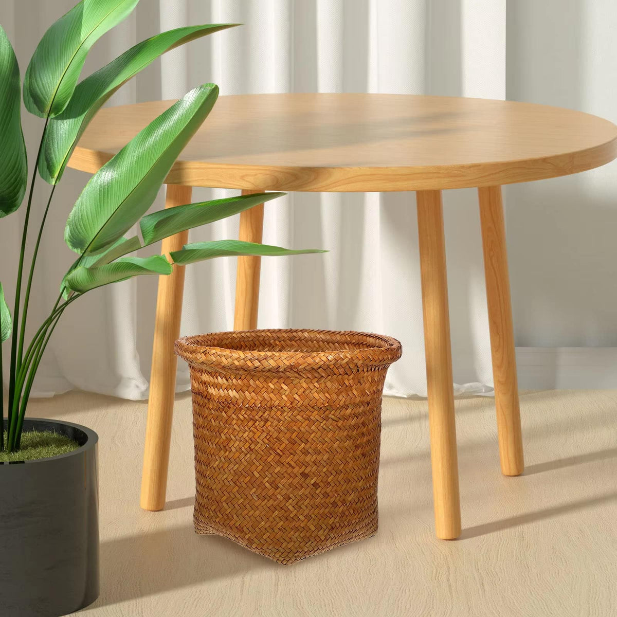 Retro handwoven rattan wastebasket in warm brown – shown in a room setting