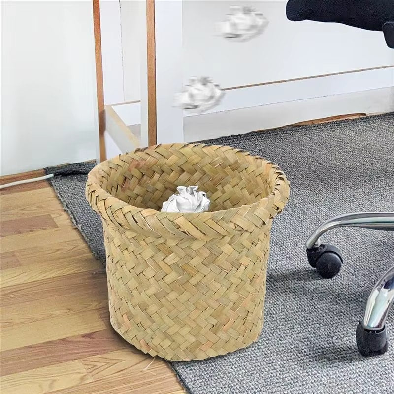 Compact round rattan wastebasket in a sand color – shown in a room setting