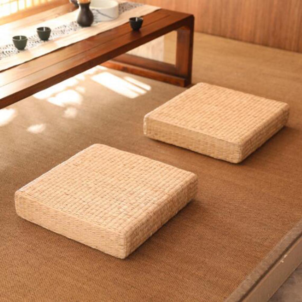 Square flat rattan pouf with a tight braid – shown in a room setting (2)