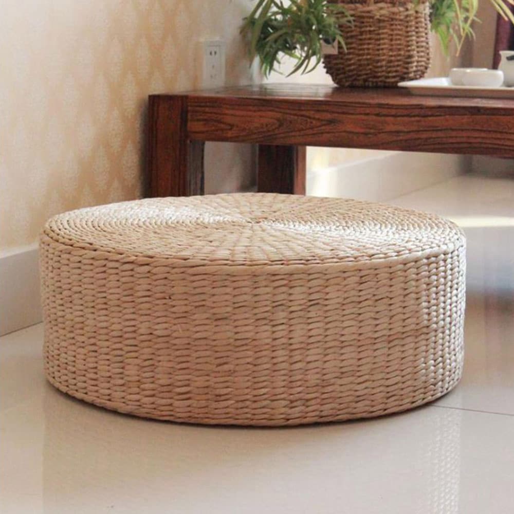 Round hand-braided natural rattan pouf – shown in a room setting (3)