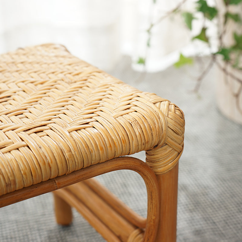 Light wood footstool with a hand-braided rattan top – close-up detail