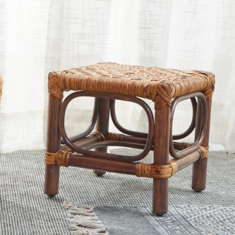 Dark brown wood footstool with a hand-braided rattan seat