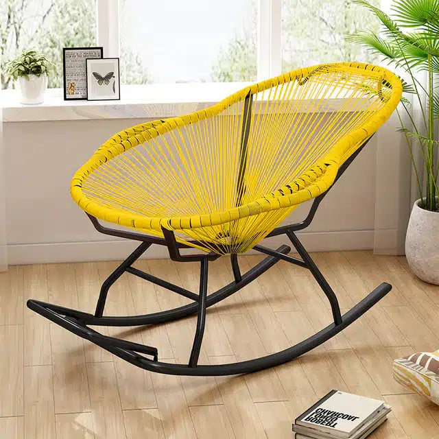 Modern black lacquered rattan rocking chair – shown outdoors