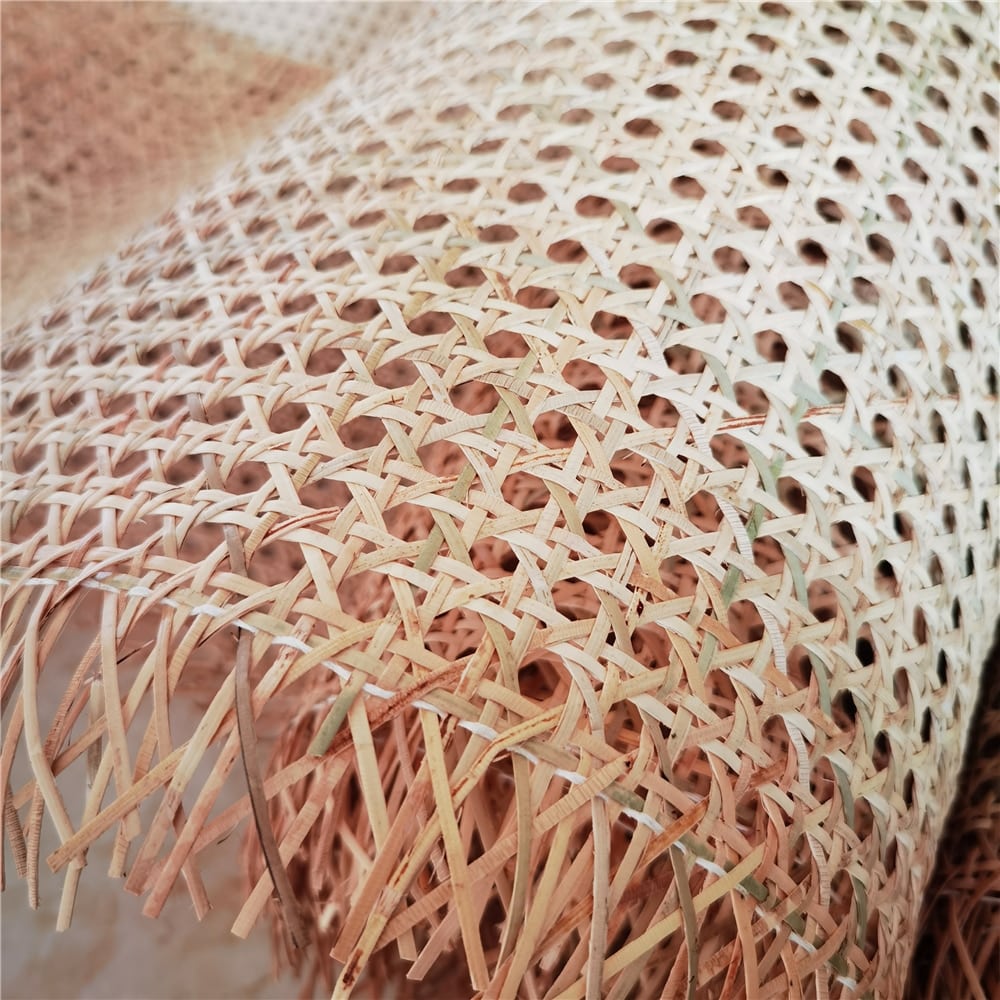 Green-tinted round mesh rattan cane webbing roll – close-up detail