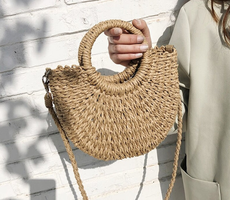 Half-moon woven rattan crossbody bag – worn by a model