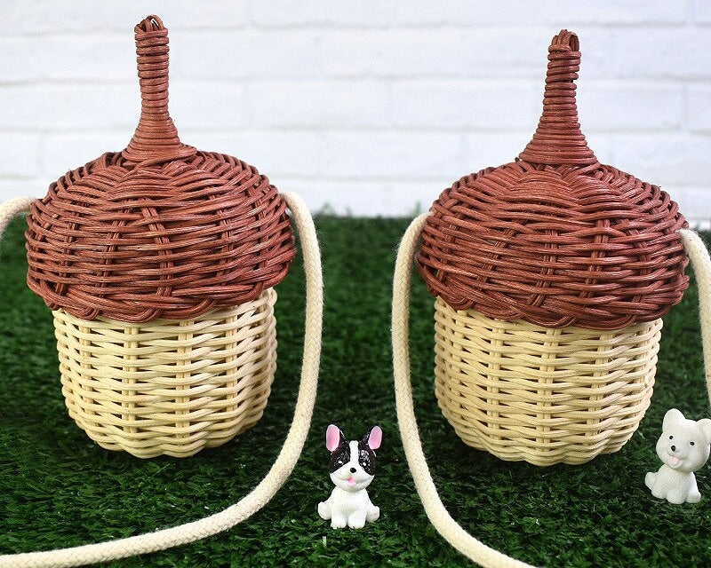Rounded woven rattan shoulder bag – shown outdoors