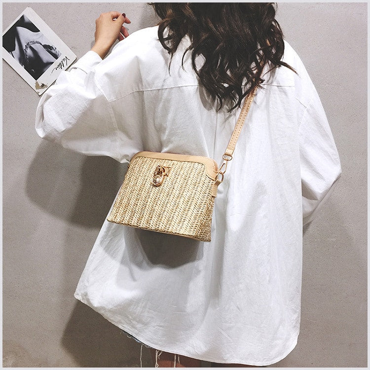 Brown rattan beach bag with a gold chain – worn by a model (2)