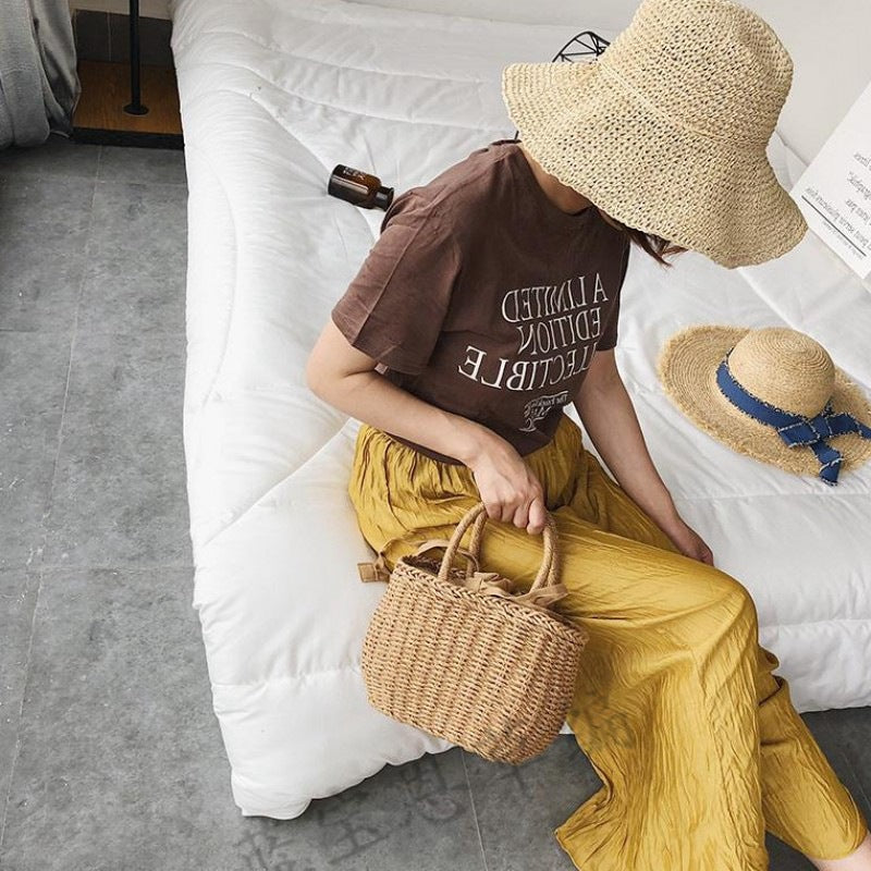 Structured handwoven rattan bag – worn by a model (3)