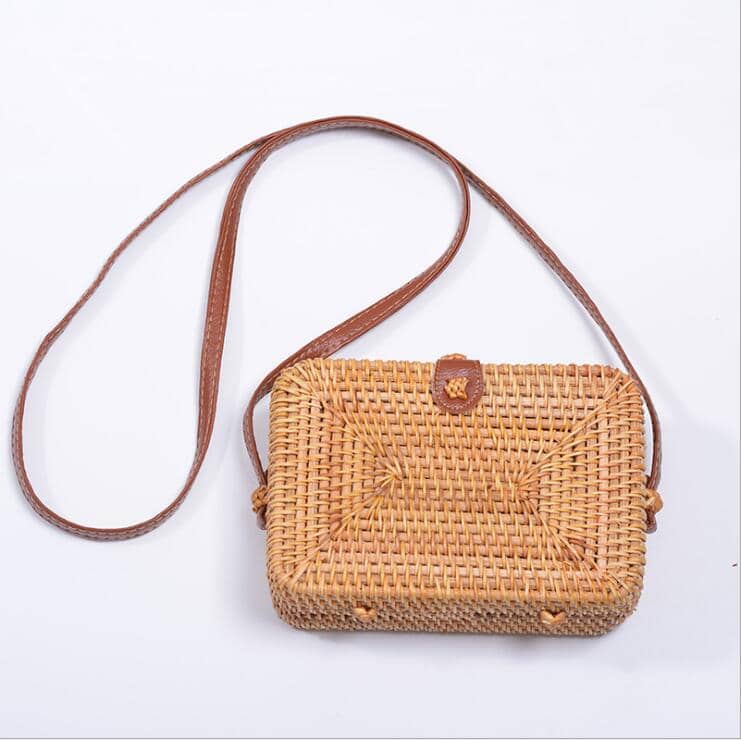 Rectangular rattan handbag with a button closure